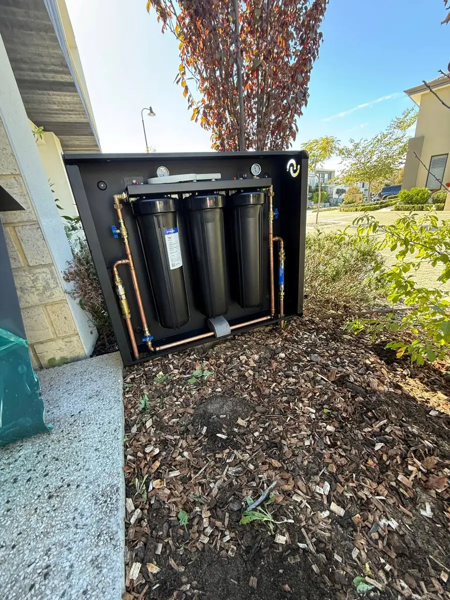 Jac & Co 3-stage whole-house filtration system, cover open showing filter housings and copper manifold